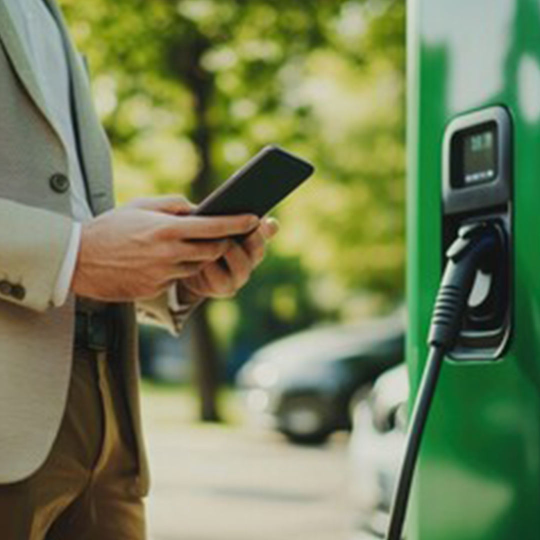 fleet driver charging EV at charging station